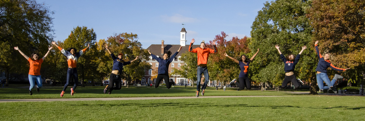 students jumping on the Quad