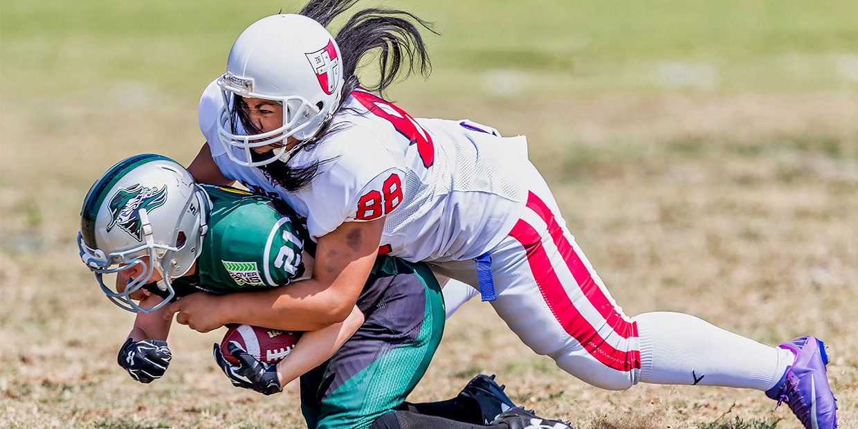 Football player tackling their opponent