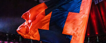 Illini flag being waved on the court of State Farm Center during a men's basketball game