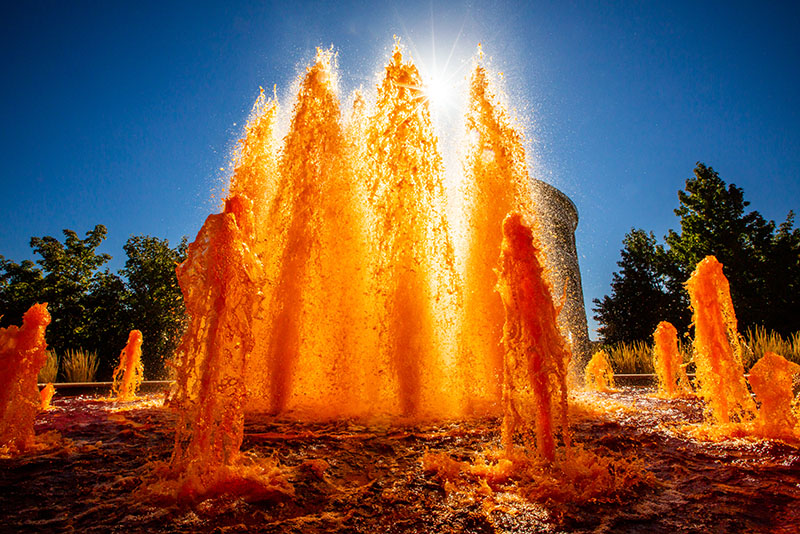 the Hallene Gateway fountain dyed orange in celebration of Homecoming weekend