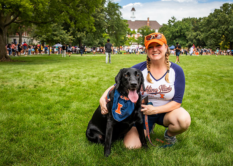 dog and her owner posing on the Quad, both decked out in Illini gear