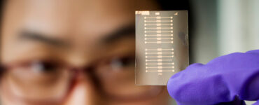a researcher holds a sensor made from a porous thin film of organic conductive plastics - designed to be portable, disposable device for medical and environmental monitoring