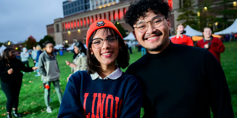 two students at a Homecoming celebration and concert outside Memorial Stadium