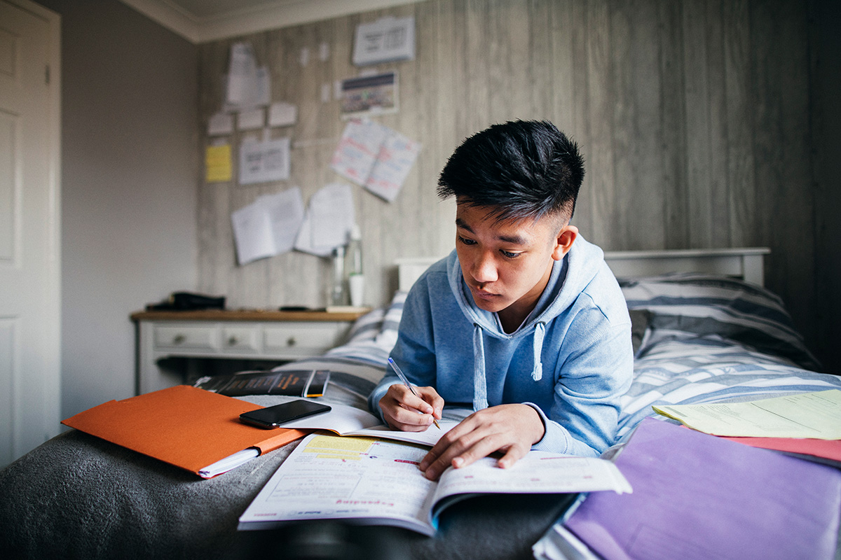 student preparing for exams in their room