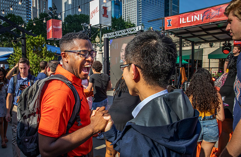 two friends happily running into each other at the Illini Fest celebration in Chicago