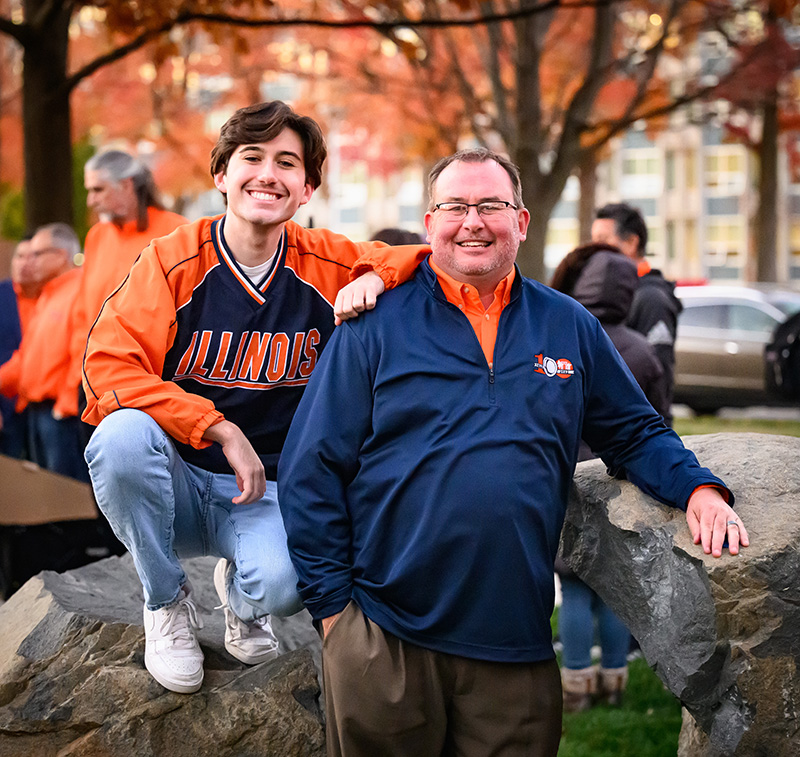Illinois-geared father and son at the dedication of the Illini Dads Centennial Plaza